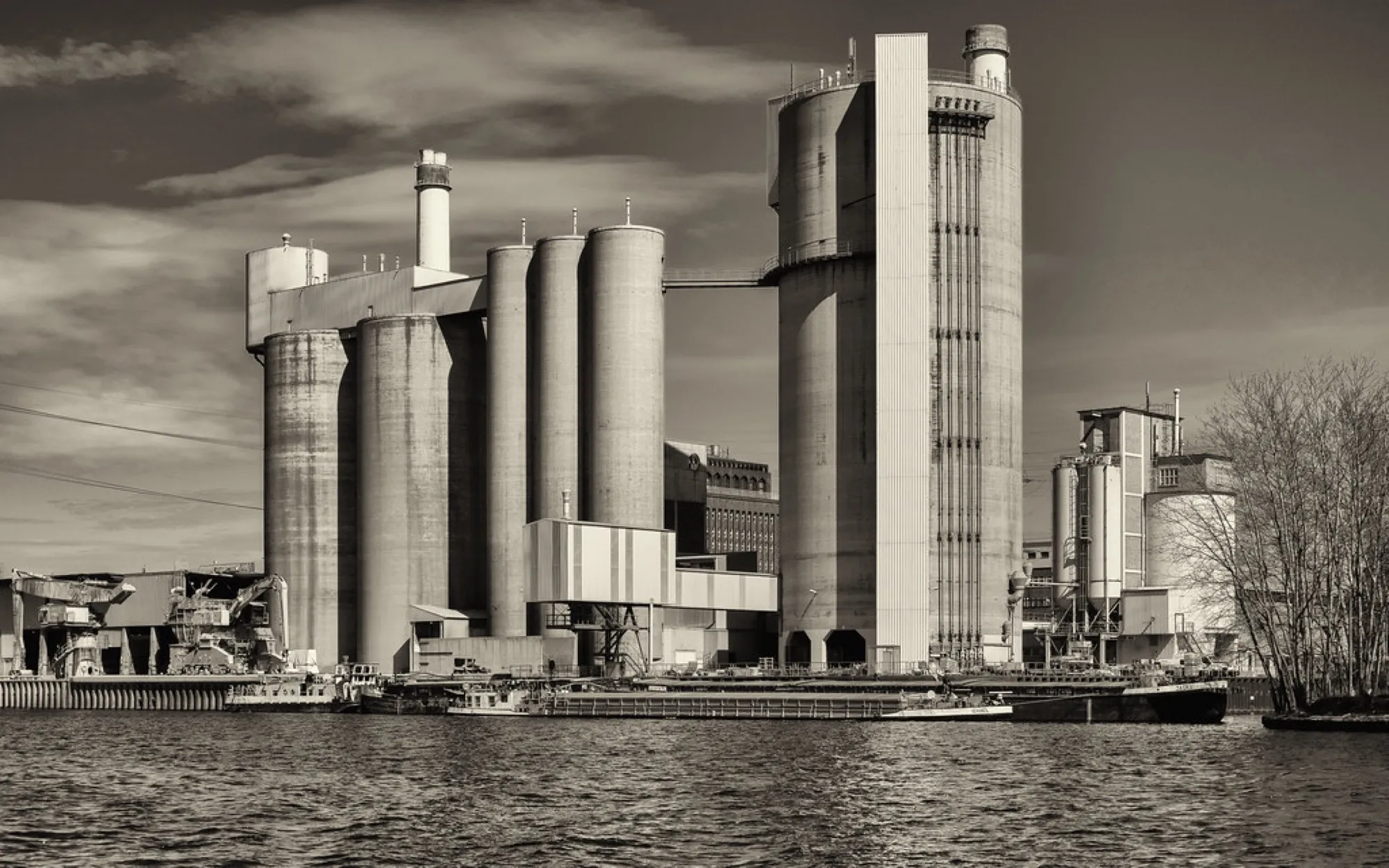 Cement plant with tall silos and a preheater tower (placeholder image)