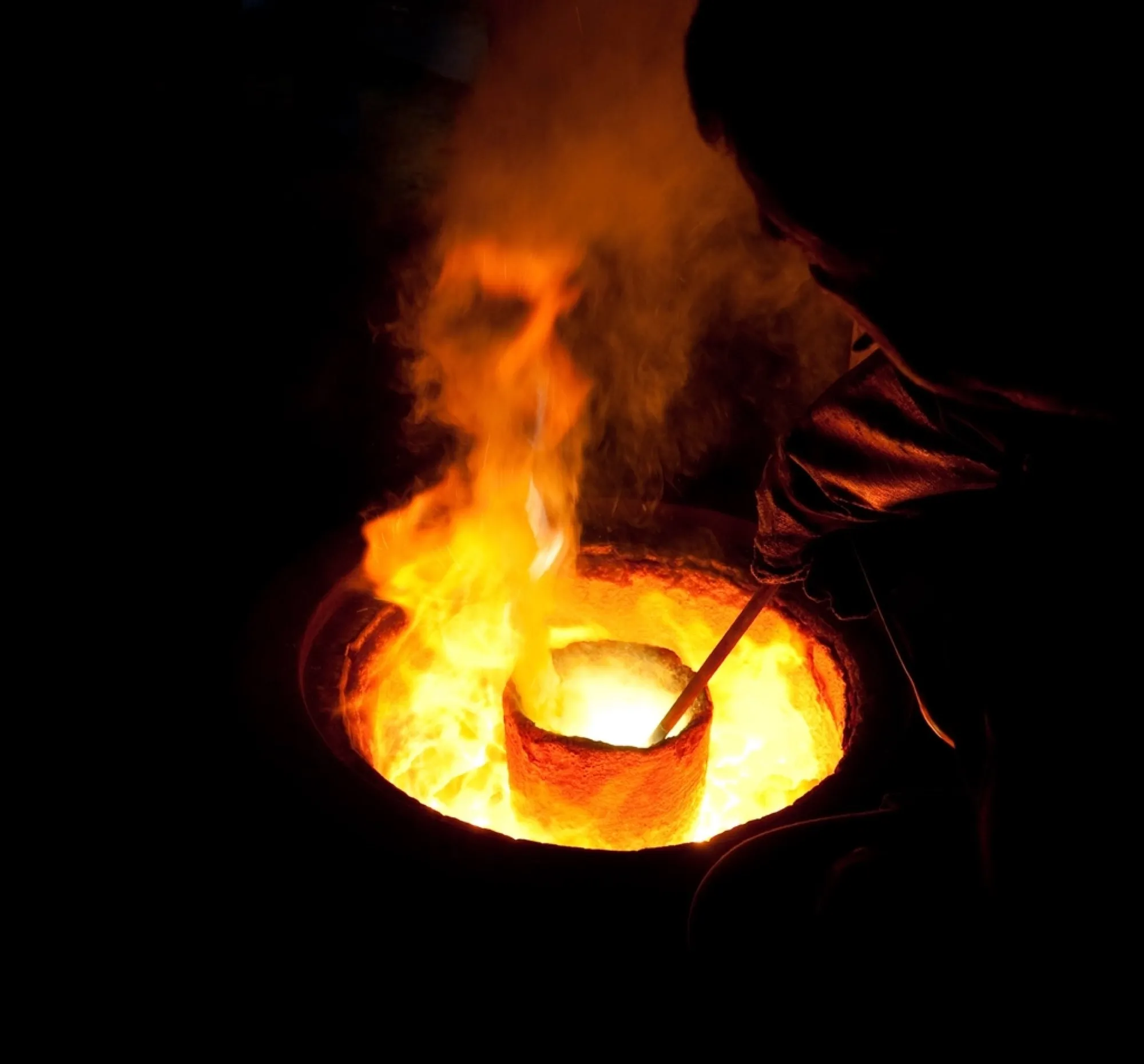 Glowing crucible of molten metal in a foundry (placeholder image)