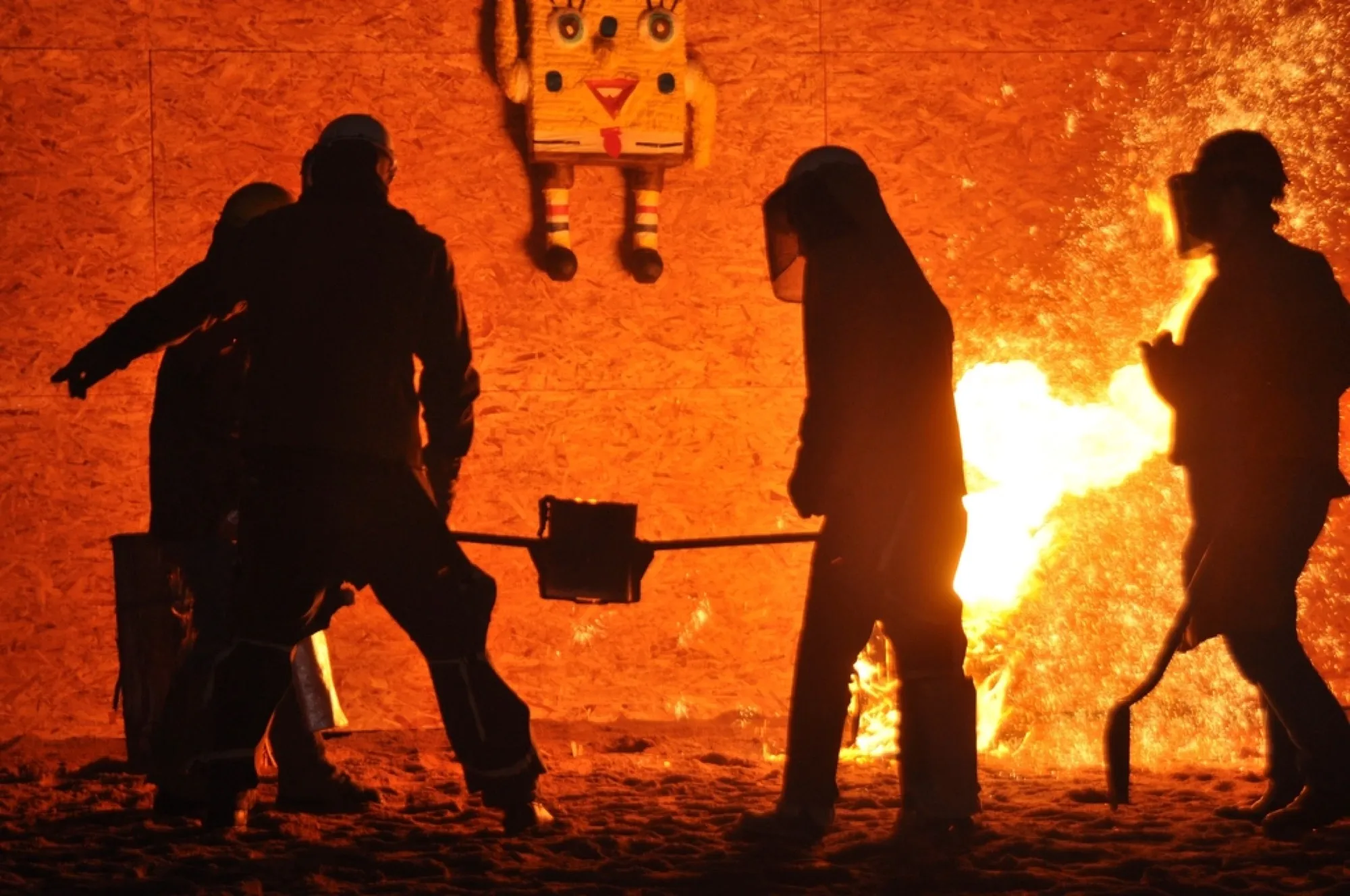 Workers in protective gear beside a glowing industrial furnace (placeholder image)