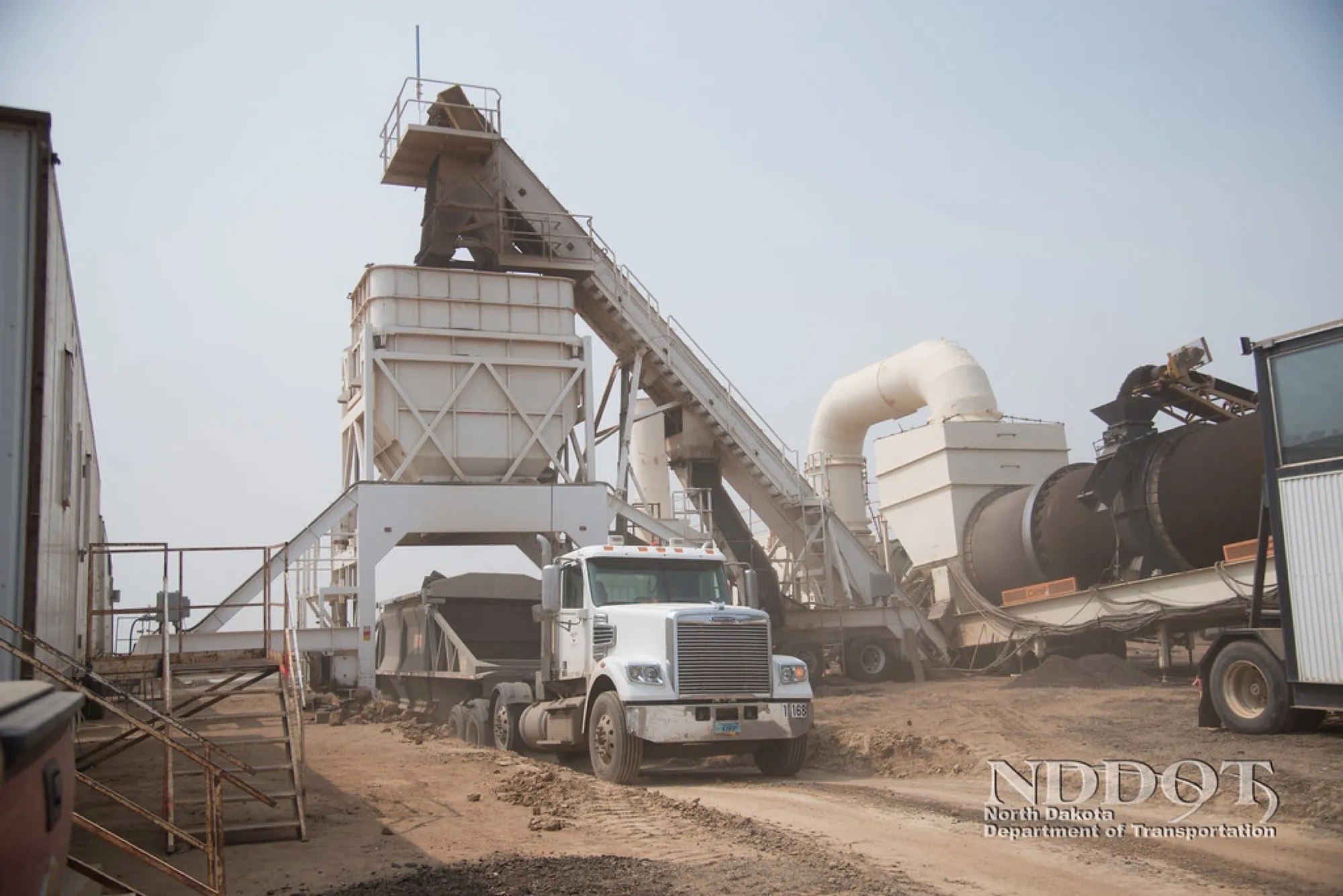 Hot-mix asphalt plant with drum dryer and a truck loading (placeholder image)
