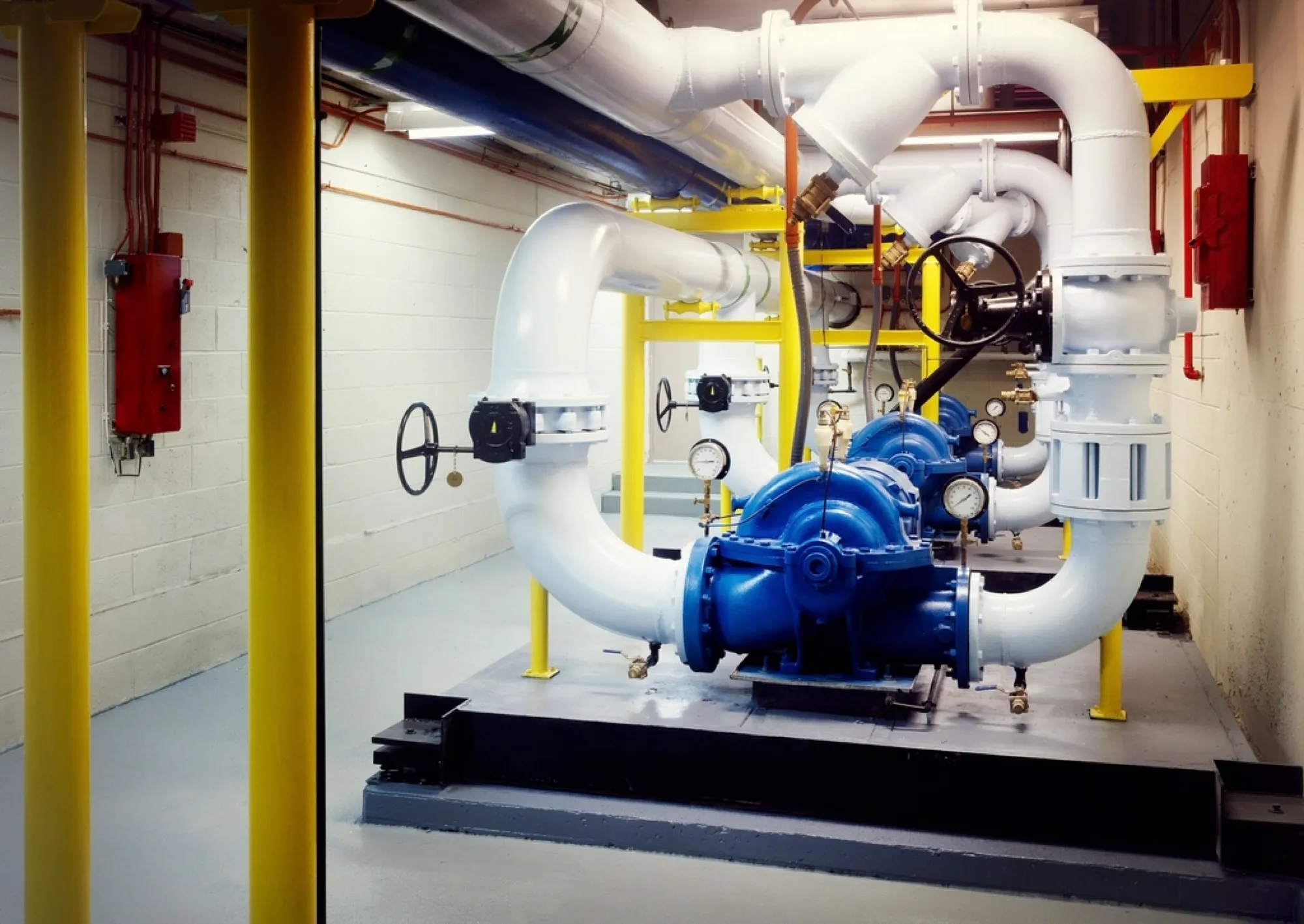 Industrial boiler room with pumps and insulated pipework (placeholder image)