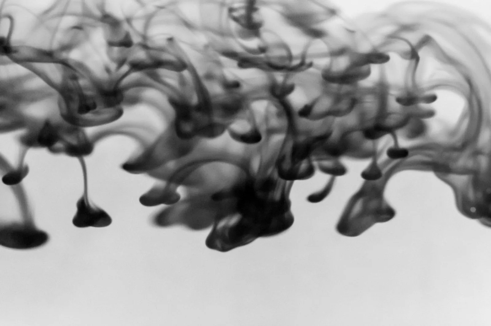 Orange liquid flowing through water, representing plastic pyrolysis oil (placeholder image)