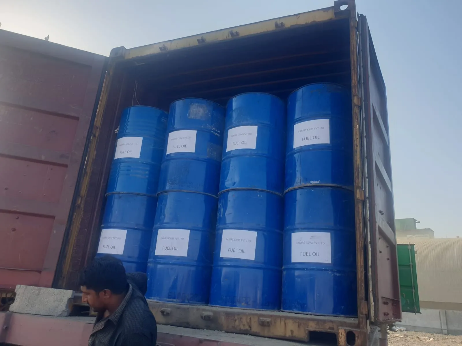 Blue 200-litre drums of fuel oil loaded in a shipping container for dispatch