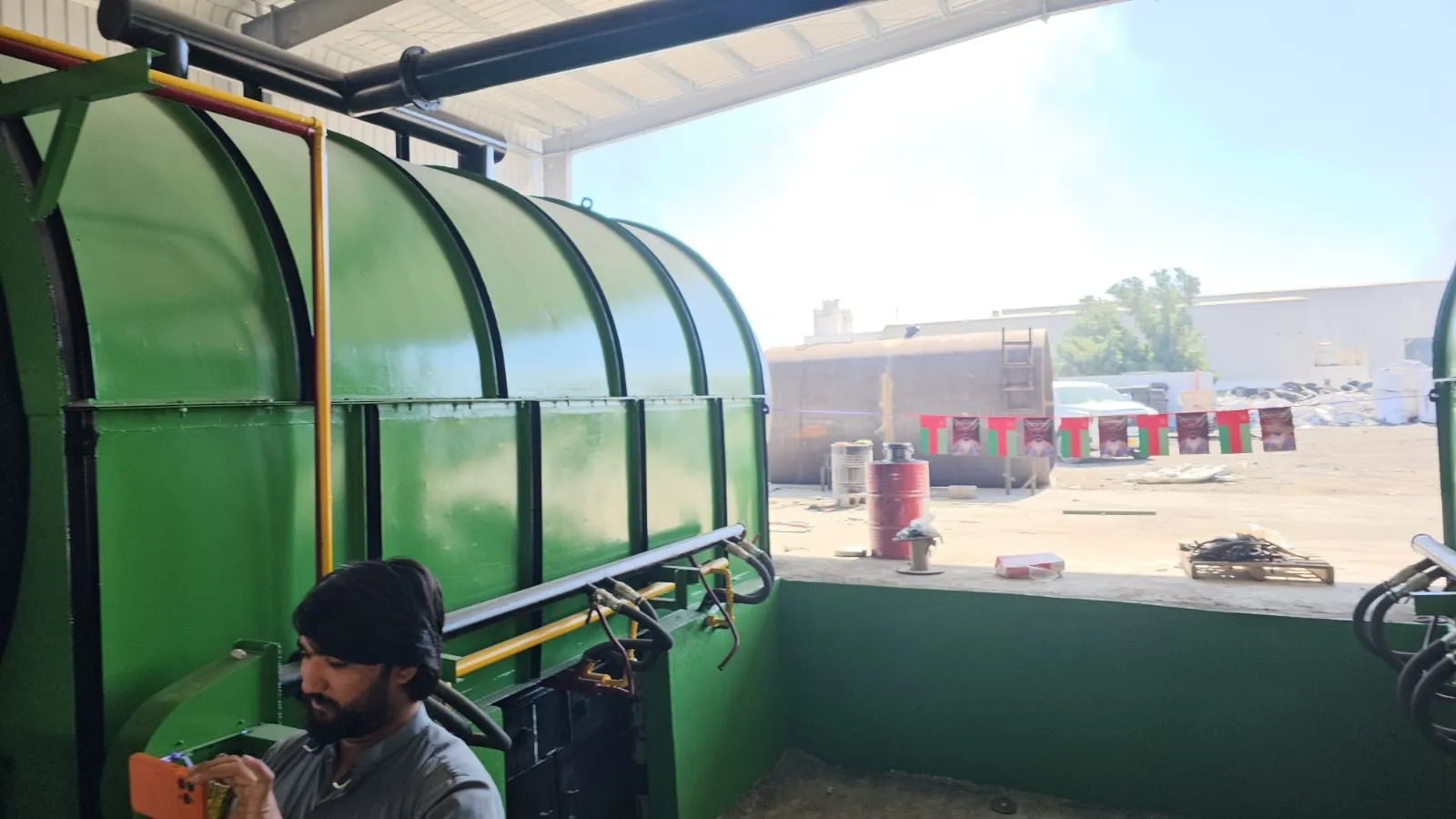 Operator beside a pyrolysis reactor at our plant