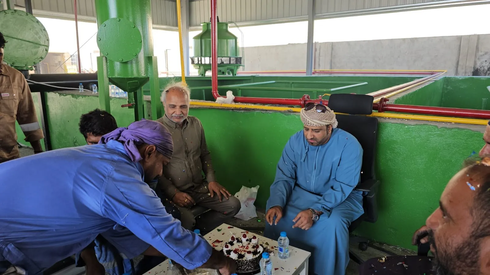 Plant team celebrating together beside the pyrolysis unit