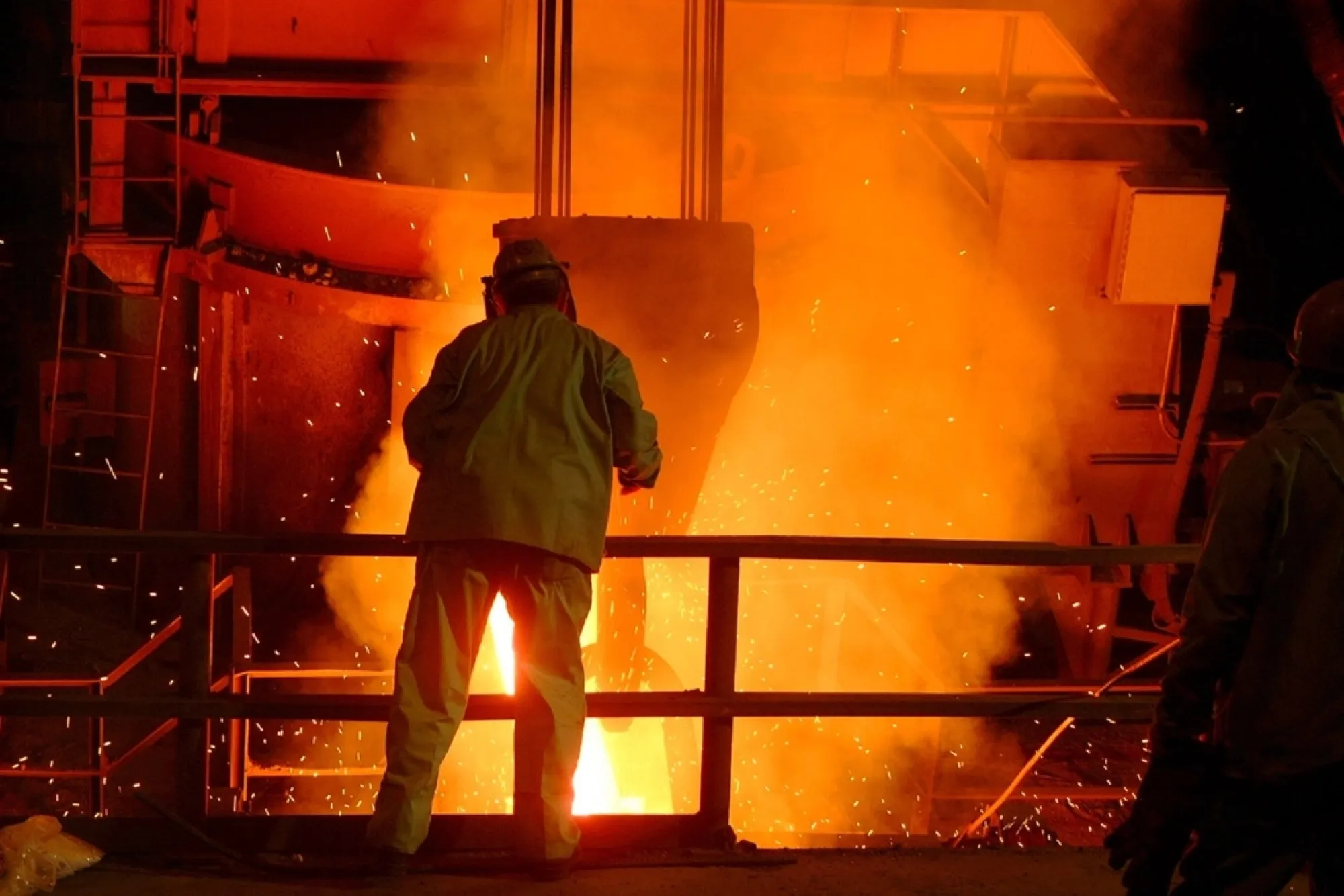 Steel mill worker beside molten metal and sparks (placeholder image)